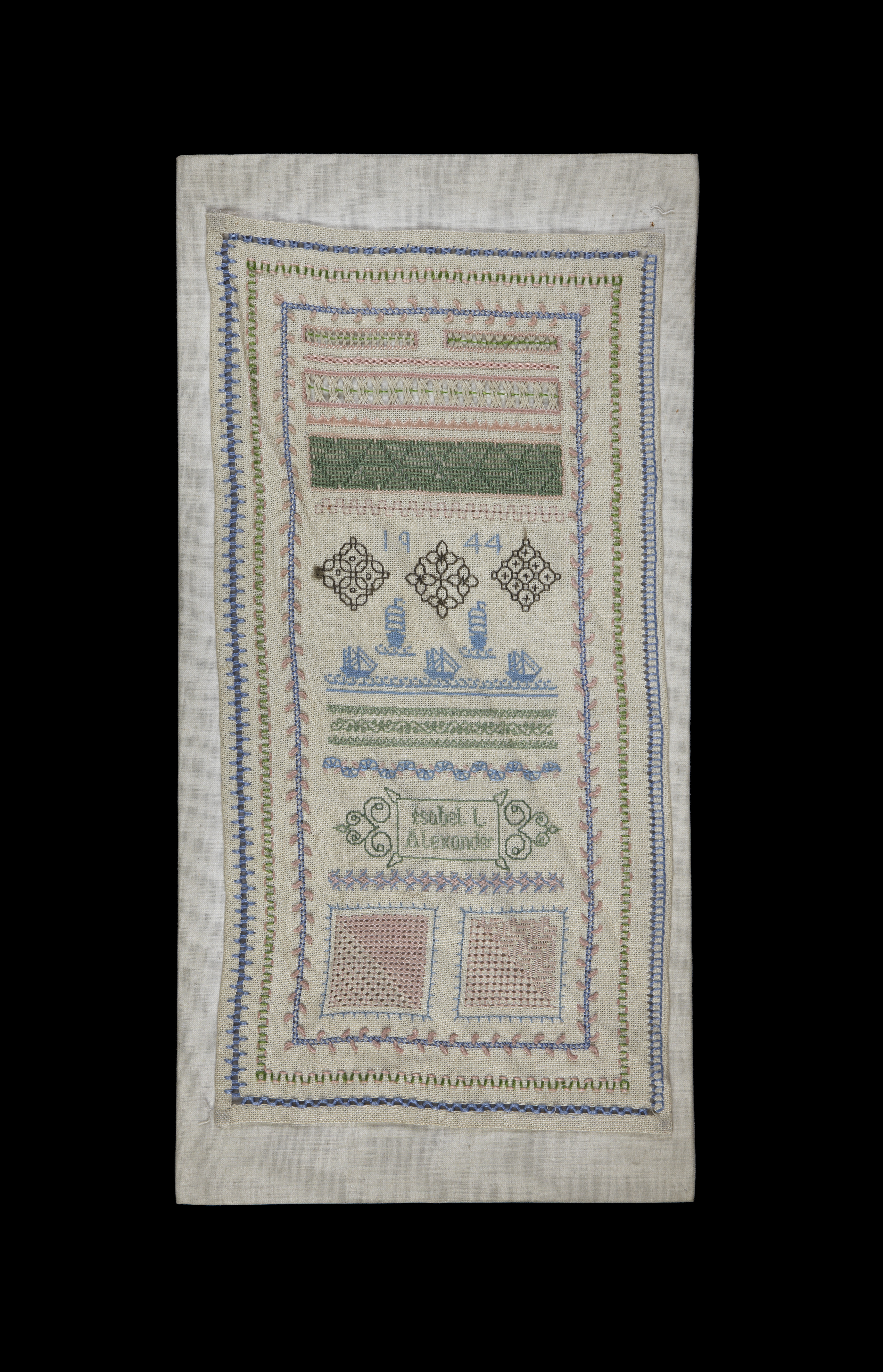 Sampler sewn onto linen