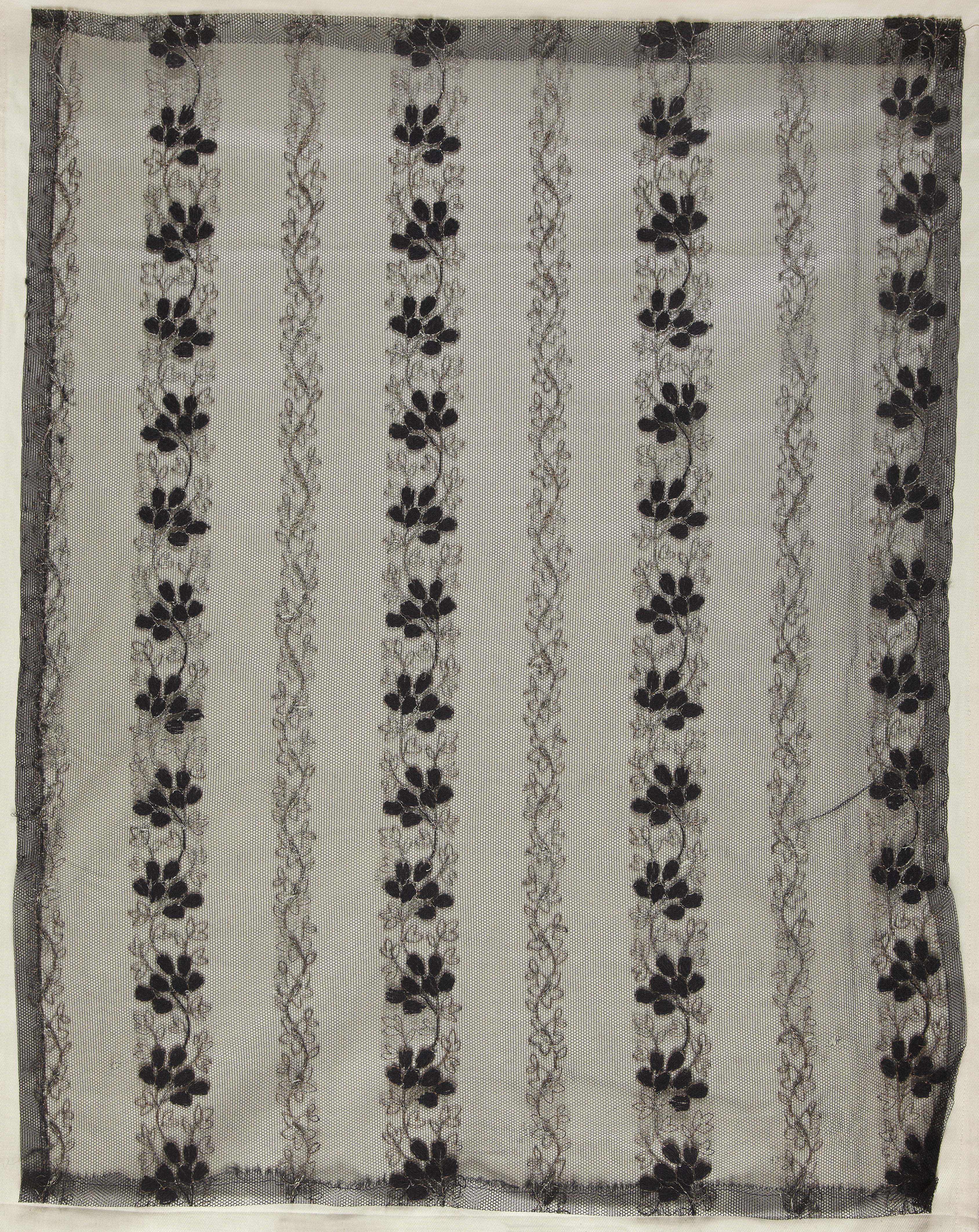 Machine embroidered net.