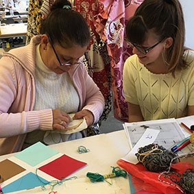 Workshop assistant with participant in stitch and design workshop